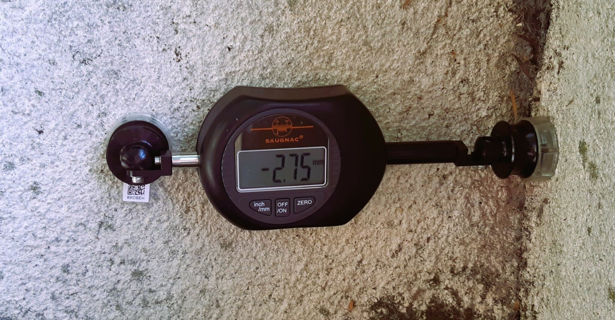E1 digital crackmeter mounted at an angle in a corner